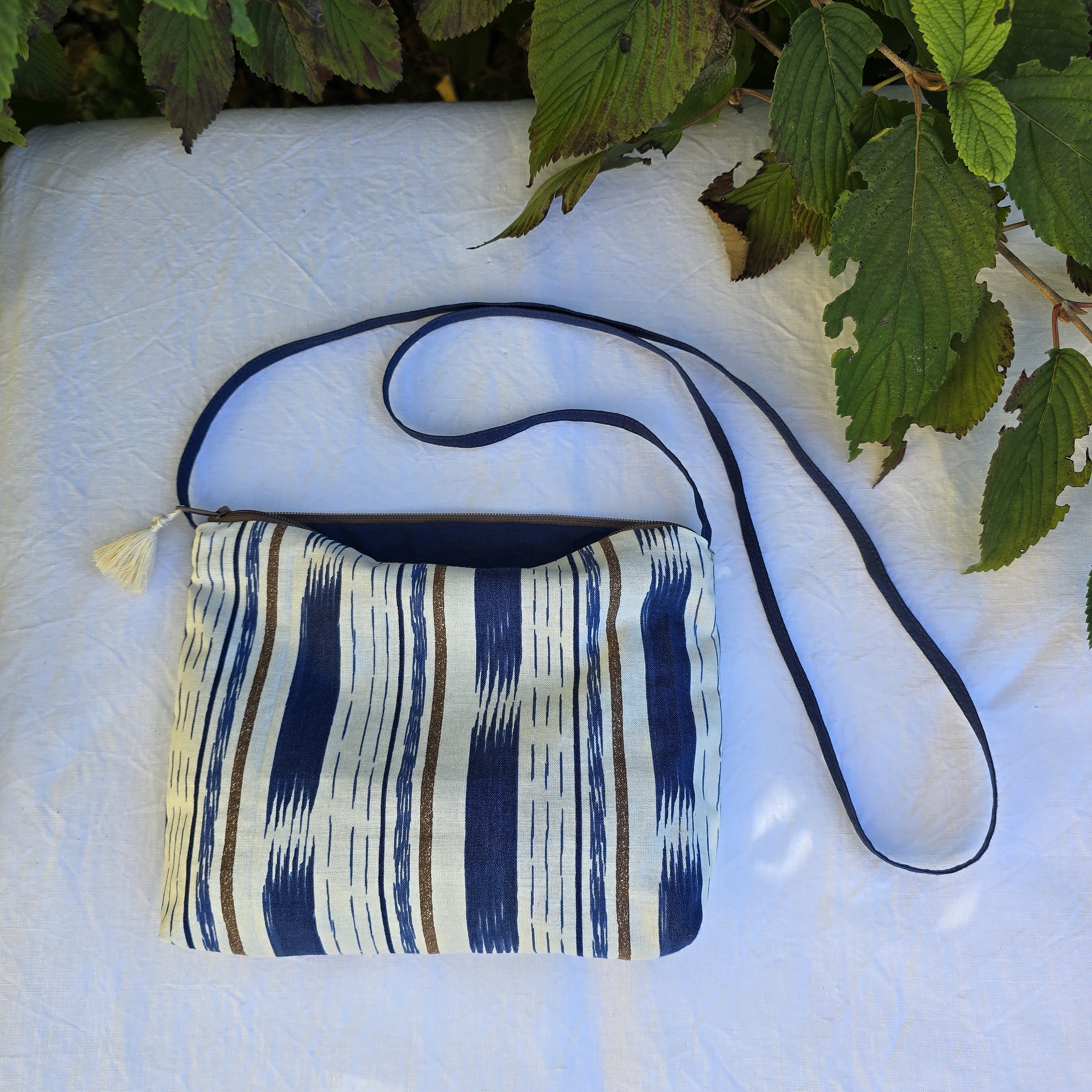 Pochette avec bandouli&egrave;re en tissu coton bleu et marron agr&eacute;ment&eacute;e d'un pompon