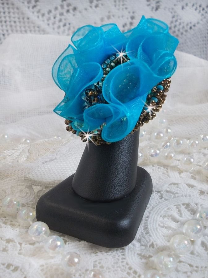 Ilycia Anillo con encanto bordado con un cabujón facetado de resina azul turquesa y una cinta de organza