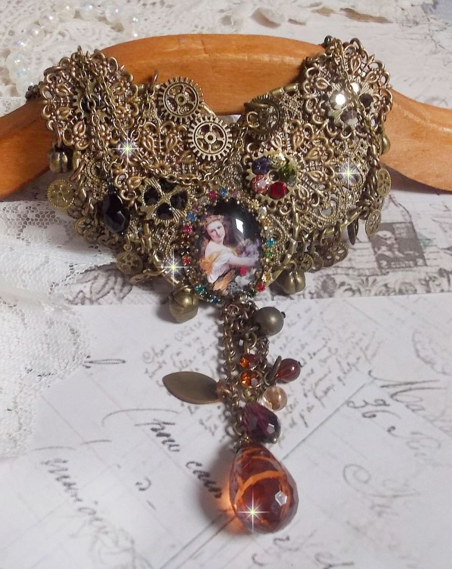 El collar Mes Passions Broc crea una mujer de cabellos dorados con flores, accesorios de bronce, dijes de cristales y una cadena de strass